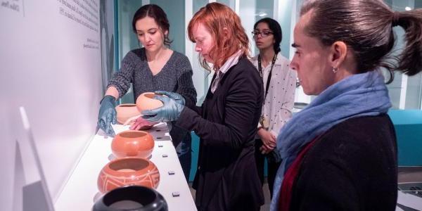 People looking at pottery