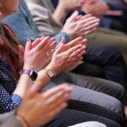 People clapping during a presentation