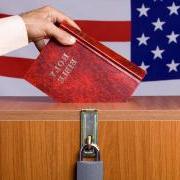 Person putting a Bible in a voting box