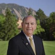 Chancellor DiStefano stands with the Flatirons behind him